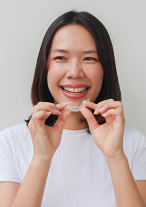 Woman's smile compared with veneers color option