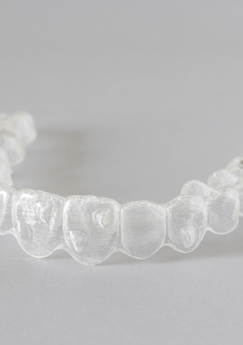  Closeup of clear aligner on gray surface