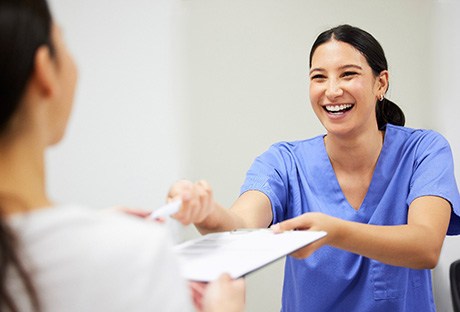 Patient in Pasadena talking with dentist about wisdom tooth extraction financing